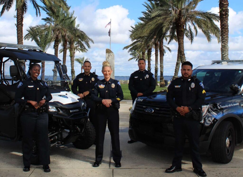 Five Members of the Sanford Police Department posing in front of Lake Monroe