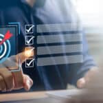 a man is checking off an item on the to-do list in the hopes of hitting a goal