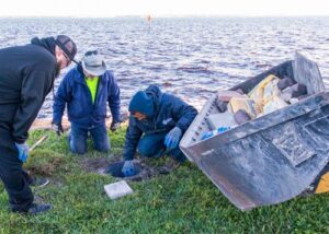 City workers installing concrete base for a purple martin pole at the Lake Monroe shoreline